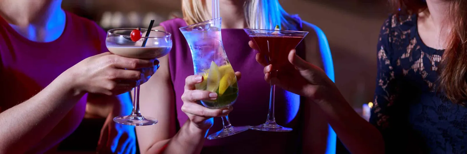 Three female friends toasting in the bar