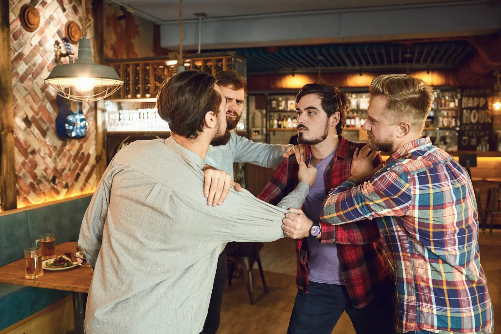 Men fight in a pub bar. Drunk people are fighting in a pub.