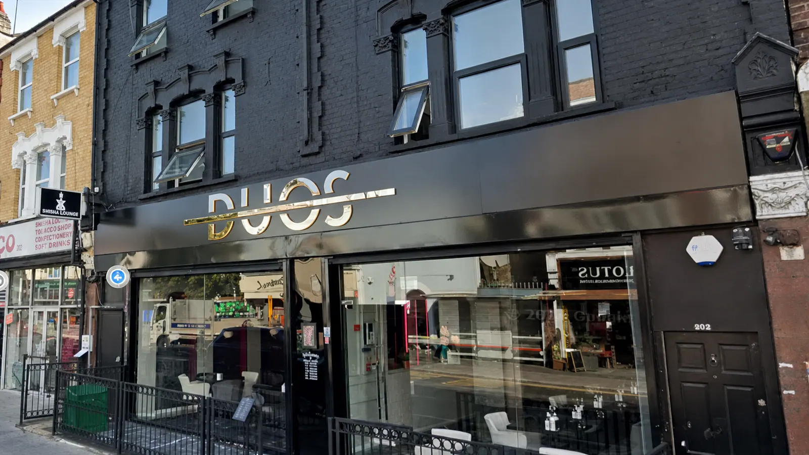 The Duos shopfront on Lea Bridge Road, with its black frontage and gold lettering